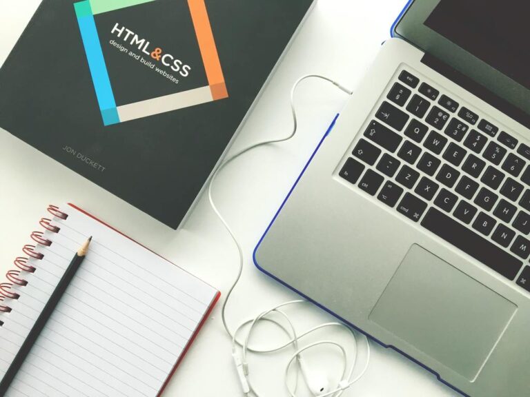 Laptop with HTMl and CC Manual next to it